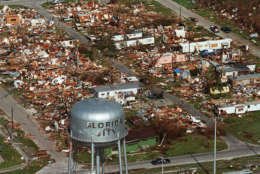 FILE - This Aug. 25, 1992 file photo shows the water tower, a landmark in Florida City, Fla. still standing over the ruins of the Florida coastal community that was hit by the force of Hurricane Andrew. Several days after it almost dissipated, Andrew rapidly strengthened and was a Category 4 storm at landfall in Homestead, Fla. The Hurricane Center measured a peak wind gust of 164 mph. Andrew continued into the Gulf of Mexico before reaching the central Louisiana coast as a Category 3 hurricane. Andrew was blamed for 23 deaths in the U.S. and three deaths in the Bahamas and caused an estimated $26.5 billion in damage in the United States. (AP Photo, File)