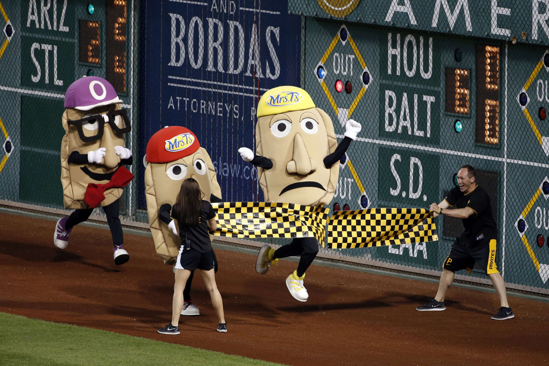 Cheese Chester breaks the tape to win the Pierogi Race between innings of a baseball game at PNC Park in Pittsburgh, between the Pittsburgh Pirates and the Miami Marlins, Tuesday, May 26, 2015. The Pirates won 5-1. (AP Photo/Gene J. Puskar)