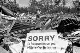 Service station owner H.A. Torgerson moves debris in what had been the town post office, next door to his station in Waveland, Miss., Sept. 11, 1969. Hurricane Camille had devastated the area about three weeks earlier. (AP Photo/Jack Thornell)