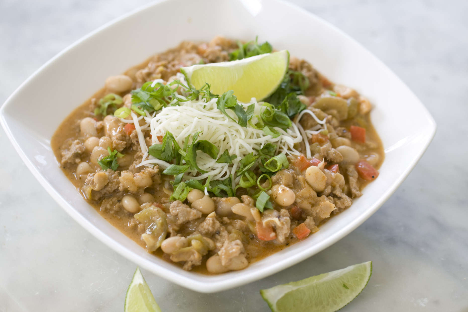 This Sept. 9, 2013 photo shows white chicken chili with lime in Concord, N.H. White beans are a good source of fiber - which means this chili will fill you up - and a very good source of folate and manganese. (AP Photo/Matthew Mead)