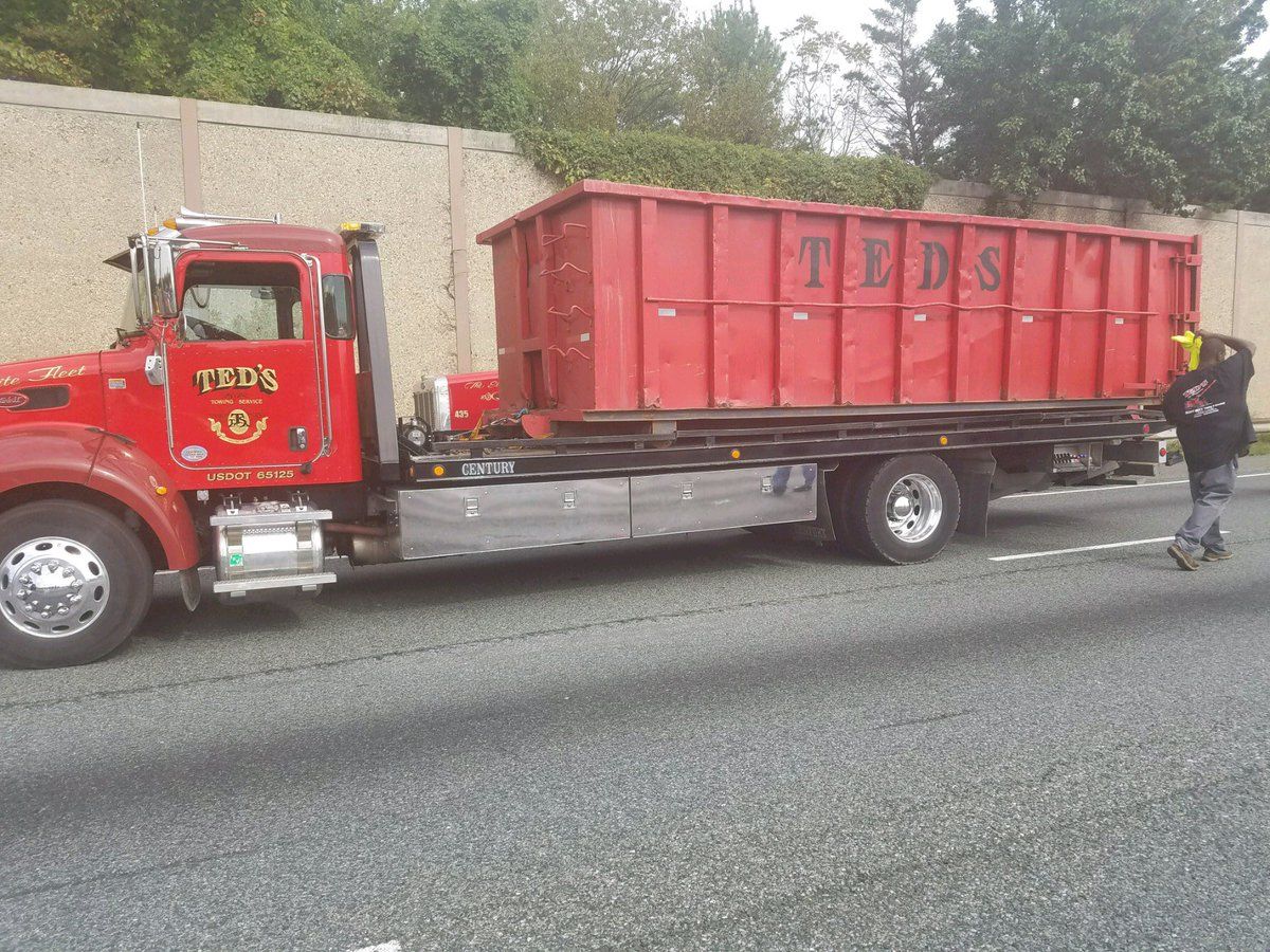 Dumpsters arrive at the scene of the tractor-trailer fire to assist with cleanup. (Courtesy Maryland State Police)