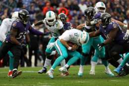 BALTIMORE, MD - DECEMBER 4: Quarterback Ryan Tannehill #17 of the Miami Dolphins is sacked by outside linebacker Terrell Suggs #55 and defensive end Timmy Jernigan #99 of the Baltimore Ravens in the second quarter at M&amp;T Bank Stadium on December 4, 2016 in Baltimore, Maryland. (Photo by Rob Carr/Getty Images)