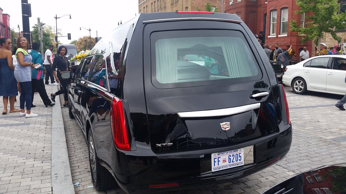 The car with Dick Gregory's casket in front of The Howard Theatre, where a celebration of his life was taking place this morning. (WTOP/Kathy Stewart) 