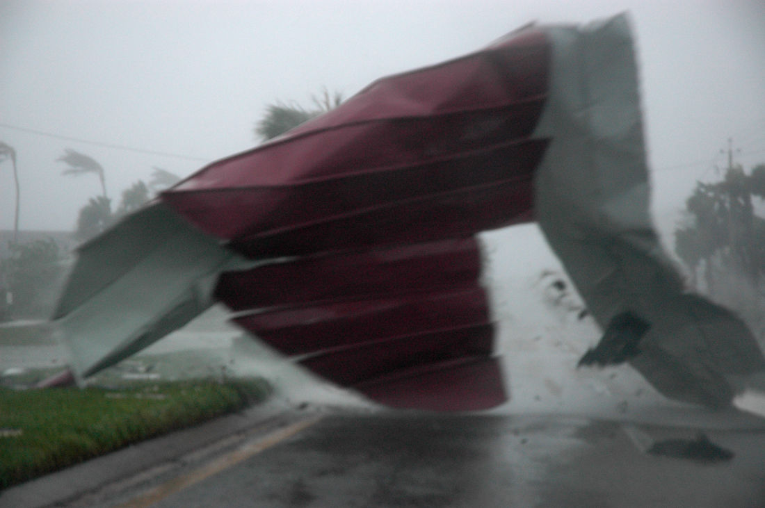 A large section of roof torn from a strip mall is blown across  Collier Boulevard during Hurricane Wilma. (WTOP/Dave Dildine)