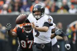 Baltimore Ravens quarterback Joe Flacco (5) looks to pass under pressure from Cincinnati Bengals defensive tackle Geno Atkins (97) in the first half of an NFL football game, Sunday, Jan. 1, 2017, in Cincinnati. (AP Photo/Gary Landers)