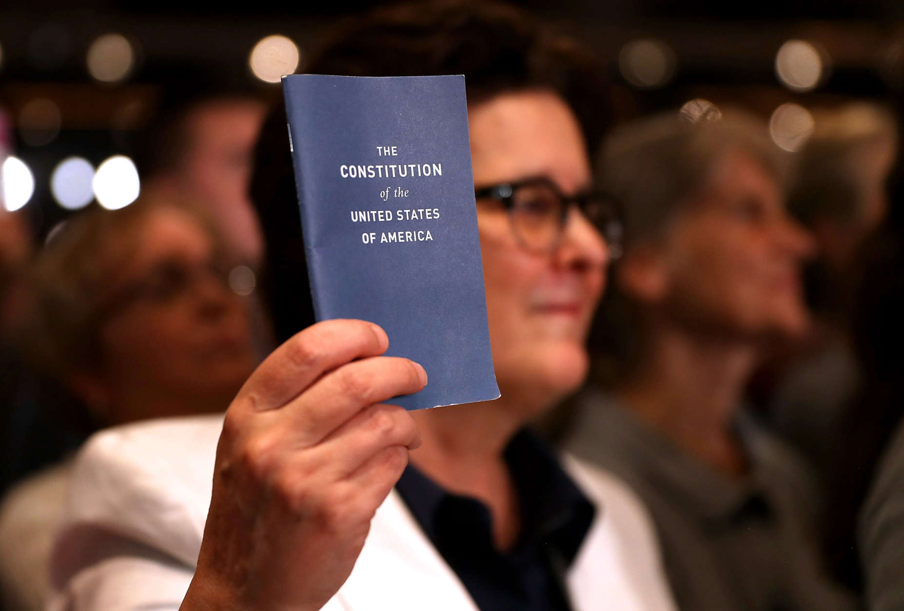 MANCHESTER, NH - NOVEMBER 06:  A supporter holds a copy of the U.S. Constitution during a campaign rally with Democratic presidential nominee former Secretary of State Hillary Clinton at The Armory on November 6, 2016 in Manchester, New Hampshire. With two days to go until election day, Hillary Clinton is campaigning in Florida and Pennsylvania.  (Photo by Justin Sullivan/Getty Images)