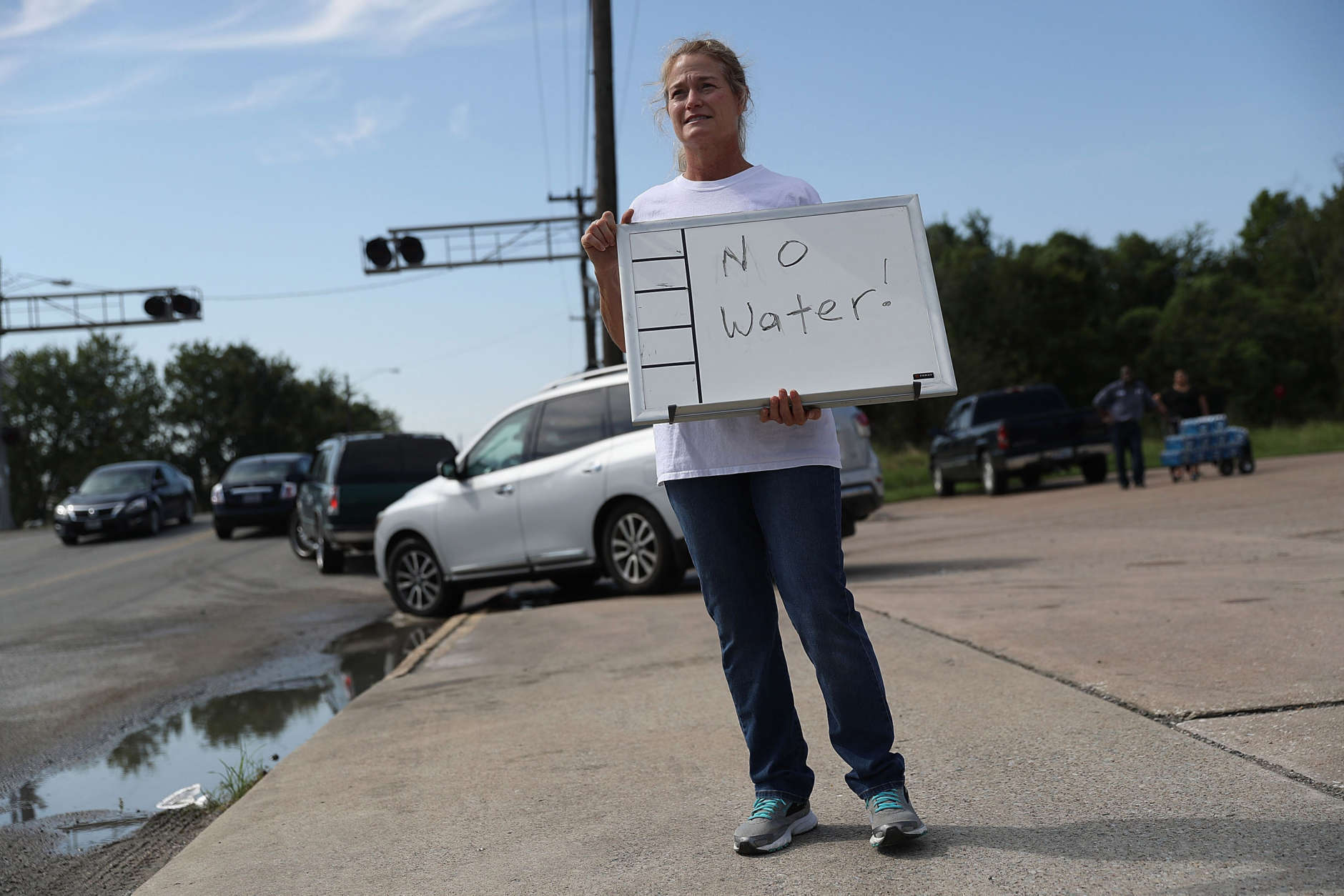BEAUMONT, TX - AUGUST 31: Barbara Nelson from Coastal Industrial and Specialty gas welding supplies store holds a sign that reads, 'no water', after they ran out of bottled water for people that are in need after the water supply to the city of Beaumont was shut down after Hurricane Harvey passed through on August 31, 2017 in Beaumont, Texas. Harvey, which made landfall north of Corpus Christi August 25, has dumped more than 50 inches of rain in some areas in and around Houston. (Photo by Joe Raedle/Getty Images)