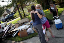 DICKINSON, TX - SEPTEMBER 01:  A Dickinson resident hugs a friend who came to help her remove possessions damaged by flooding brought on by Hurricane Harvey September 1, 2017 in Dickinson, Texas. Dickinson was hit by Hurricane Harvey extremely hard with major flooding in many areas of the city and residents there are beginning the long process of recovering from the storm.  (Photo by Win McNamee/Getty Images)