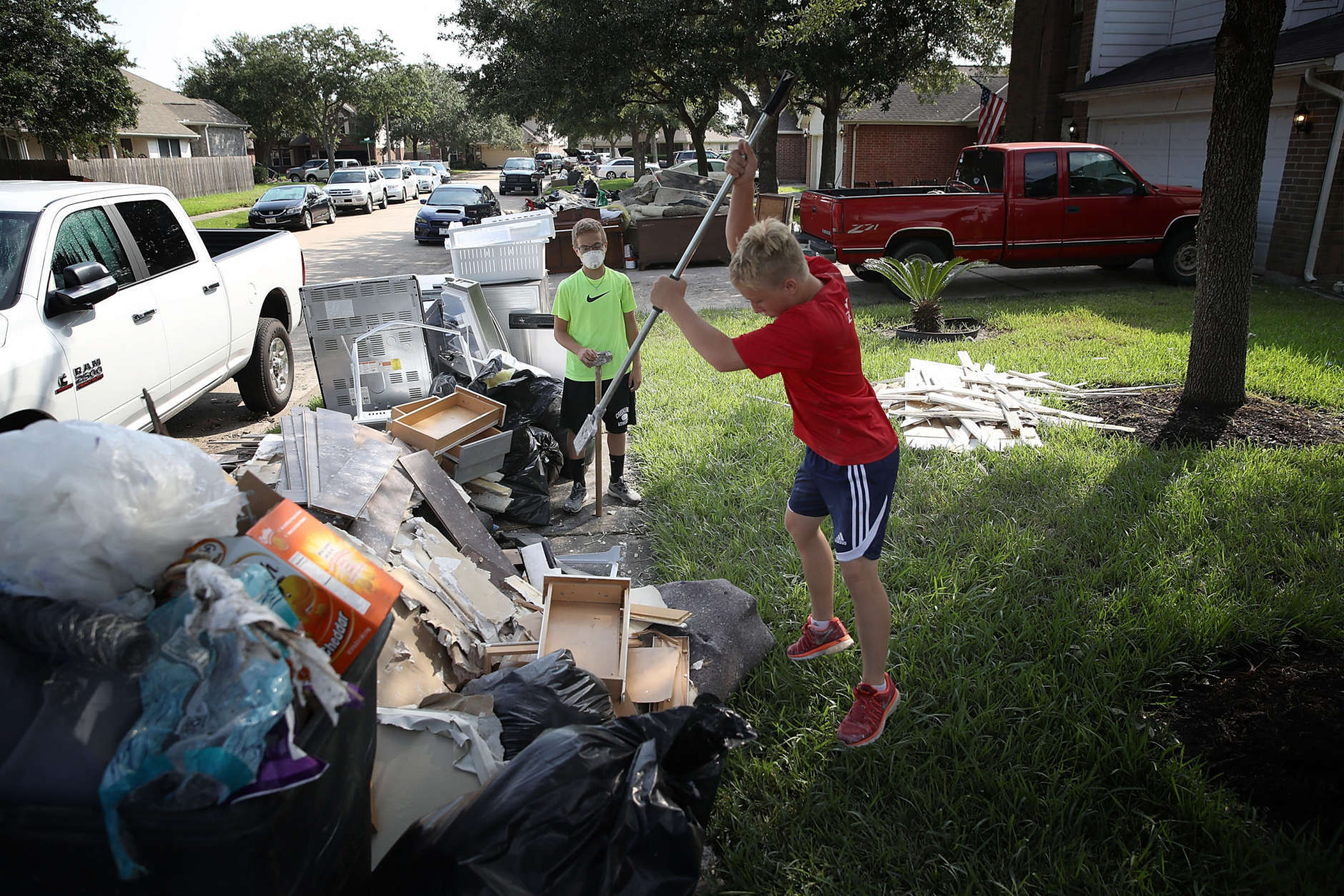 DICKINSON, TX - SEPTEMBER 01:  Dickinson residents discard possessions damaged by flooding brought on by Hurricane Harvey September 1, 2017 in Dickinson, Texas. Dickinson was hit by Hurricane Harvey extremely hard with major flooding in many areas of the city and residents there are beginning the long process of recovering from the storm.  (Photo by Win McNamee/Getty Images)