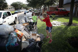 DICKINSON, TX - SEPTEMBER 01:  Dickinson residents discard possessions damaged by flooding brought on by Hurricane Harvey September 1, 2017 in Dickinson, Texas. Dickinson was hit by Hurricane Harvey extremely hard with major flooding in many areas of the city and residents there are beginning the long process of recovering from the storm.  (Photo by Win McNamee/Getty Images)