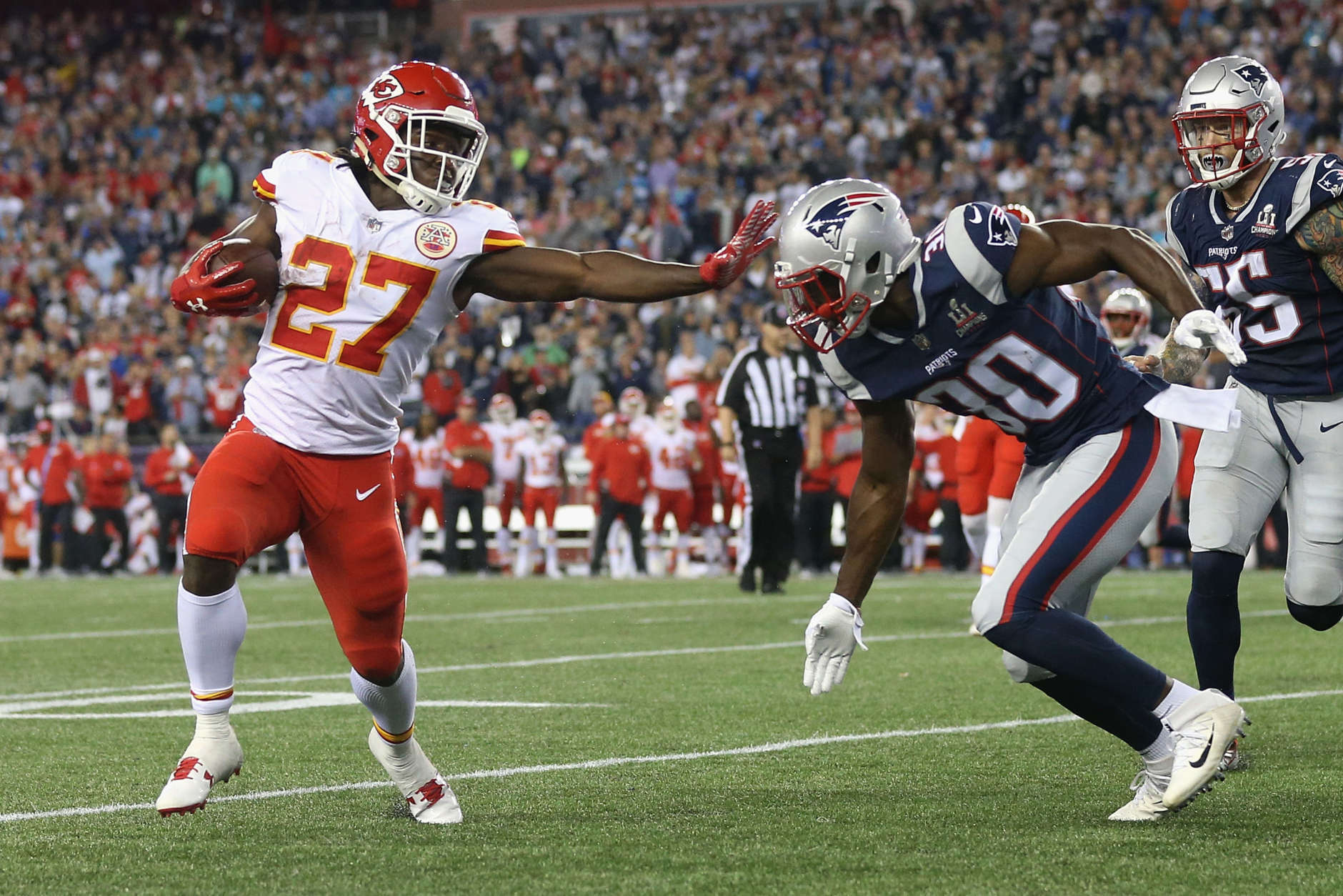 FOXBORO, MA - SEPTEMBER 07:  Kareem Hunt #27 of the Kansas City Chiefs stiff arms Duron Harmon #30 of the New England Patriots as he runs for a 4-yard rushing touchdown during the fourth quarter against the New England Patriots at Gillette Stadium on September 7, 2017 in Foxboro, Massachusetts.  (Photo by Maddie Meyer/Getty Images)
