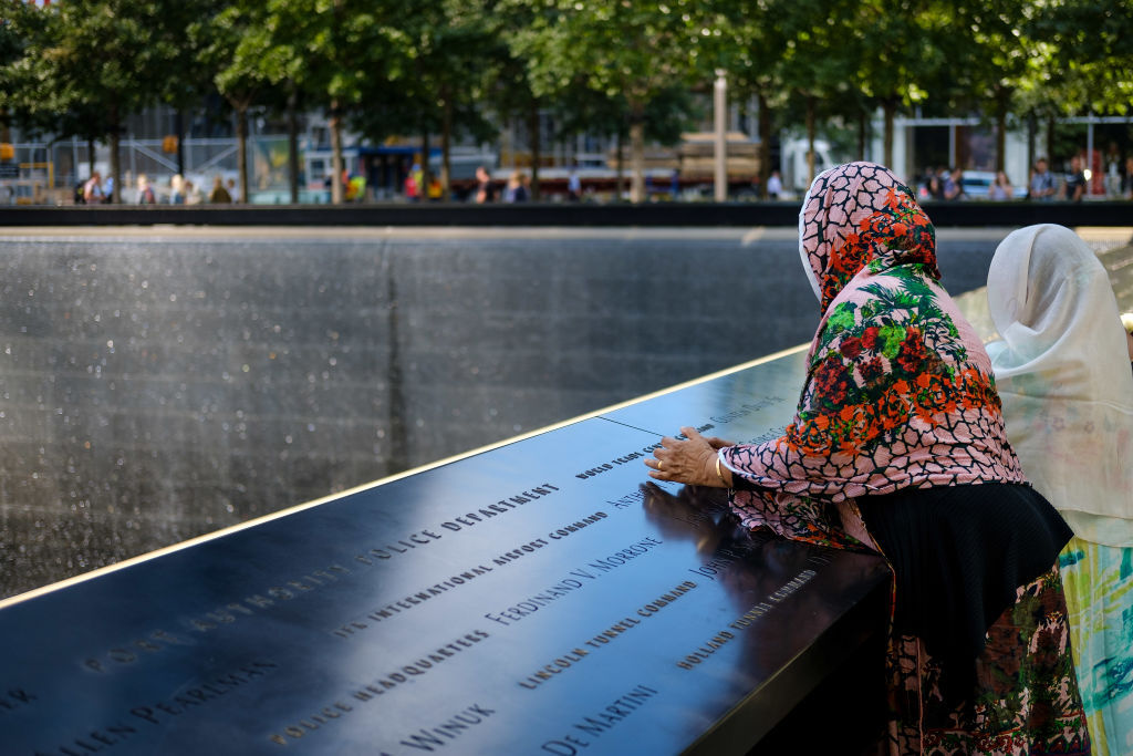 NEW YORK, NY - SEPTEMBER 8: Visitors pause at the National September 11 Memorial, September 8, 2017 in New York City. New York City is preparing to mark the 16th anniversary of the September 11th terrorist attacks that struck New York City and Washington, DC in 2001. (Photo by Drew Angerer/Getty Images)