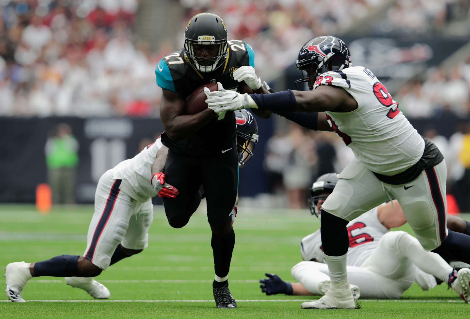 HOUSTON, TX - SEPTEMBER 10:  Leonard Fournette #27 of the Jacksonville Jaguars is tackled by Johnathan Joseph #24 and Joel Heath #93 of the Houston Texans in the first quarter at NRG Stadium on September 10, 2017 in Houston, Texas.  (Photo by Tim Warner/Getty Images)