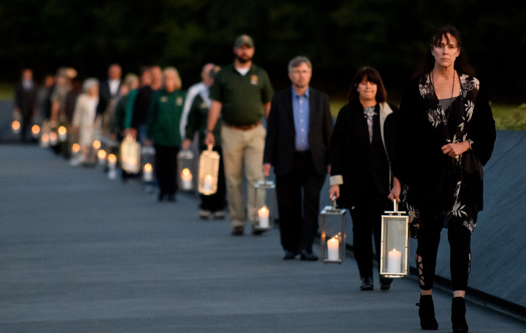SHANKSVILLE, PA - SEPTEMBER 10: Family and friends of the victims carry candles at Flight 93 National MemorialÕs annual Luminaria on the eve of 16th Anniversary ceremony of the September 11th terrorist attacks, September 10, 2017 in Shanksville, PA. United Airlines Flight 93 crashed into a field outside Shanksville, PA with 40 passengers and 4 hijackers aboard on September 11, 2001. (Photo by Jeff Swensen/Getty Images)