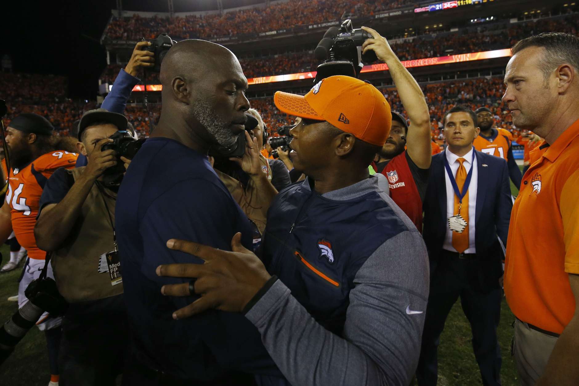 DENVER, CO - SEPTEMBER 11:  Head coach Vance Joseph of the Denver Broncos talks with head coach Anthony Lynn of the Los Angeles Chargers after the Denver Broncos won the game at Sports Authority Field at Mile High on September 11, 2017 in Denver, Colorado. (Photo by Justin Edmonds/Getty Images)