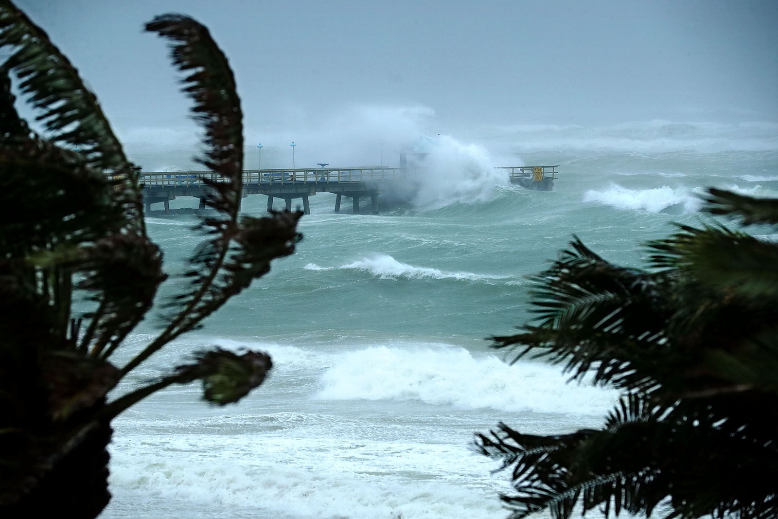 Large waves produced by Hurricane Irma crash into the end of Anglins Fishing Pier Sept. 10, 2017 in Fort Lauderdale, Florida. The category 4 hurricane made landfall in the United States in the Florida Keys at 9:10 a.m. after raking across the north coast of Cuba.  (Photo by Chip Somodevilla/Getty Images)