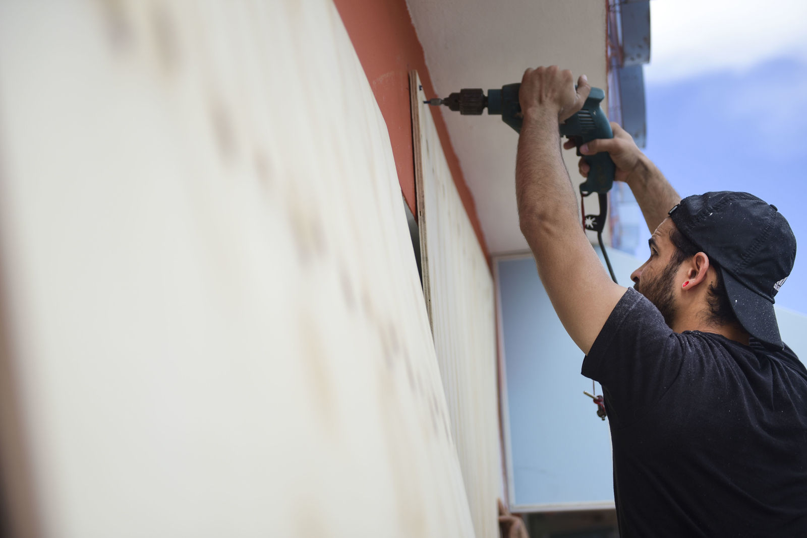 Cyber School Supply employee Christopher Rodriguez installs wood panels on windows in preparation for Hurricane Irma, in Toa Baja, Puerto Rico, Tuesday, Sept. 5, 2017. Irma grew into a dangerous Category 5 storm, the most powerful seen in the Atlantic in over a decade, and roared toward islands in the northeast Caribbean Tuesday. (AP Photo/Carlos Giusti)