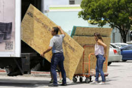 Residents load sheets of strand board on a truck as they prepare for Hurricane Irma, Tuesday, Sept. 5, 2017, in Hialeah, Fla. Hurricane Irma grew into a dangerous Category 5 storm, the most powerful seen in the Atlantic in over a decade, and roared toward islands in the northeast Caribbean Tuesday on a path that could eventually take it to the United States. (AP Photo/Alan Diaz)