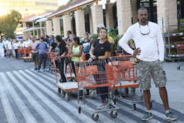 Eduardo Soriano of Miami, waits in a line since dawn to purchase plywood sheets at a Home Depot store in North Miami, Fla., Wednesday, Sept. 6, 2017. Florida residents are preparing for the possible landfall of Hurricane Irma, the most powerful Atlantic Ocean hurricane in recorded history. (AP Photo/Marta Lavandier)