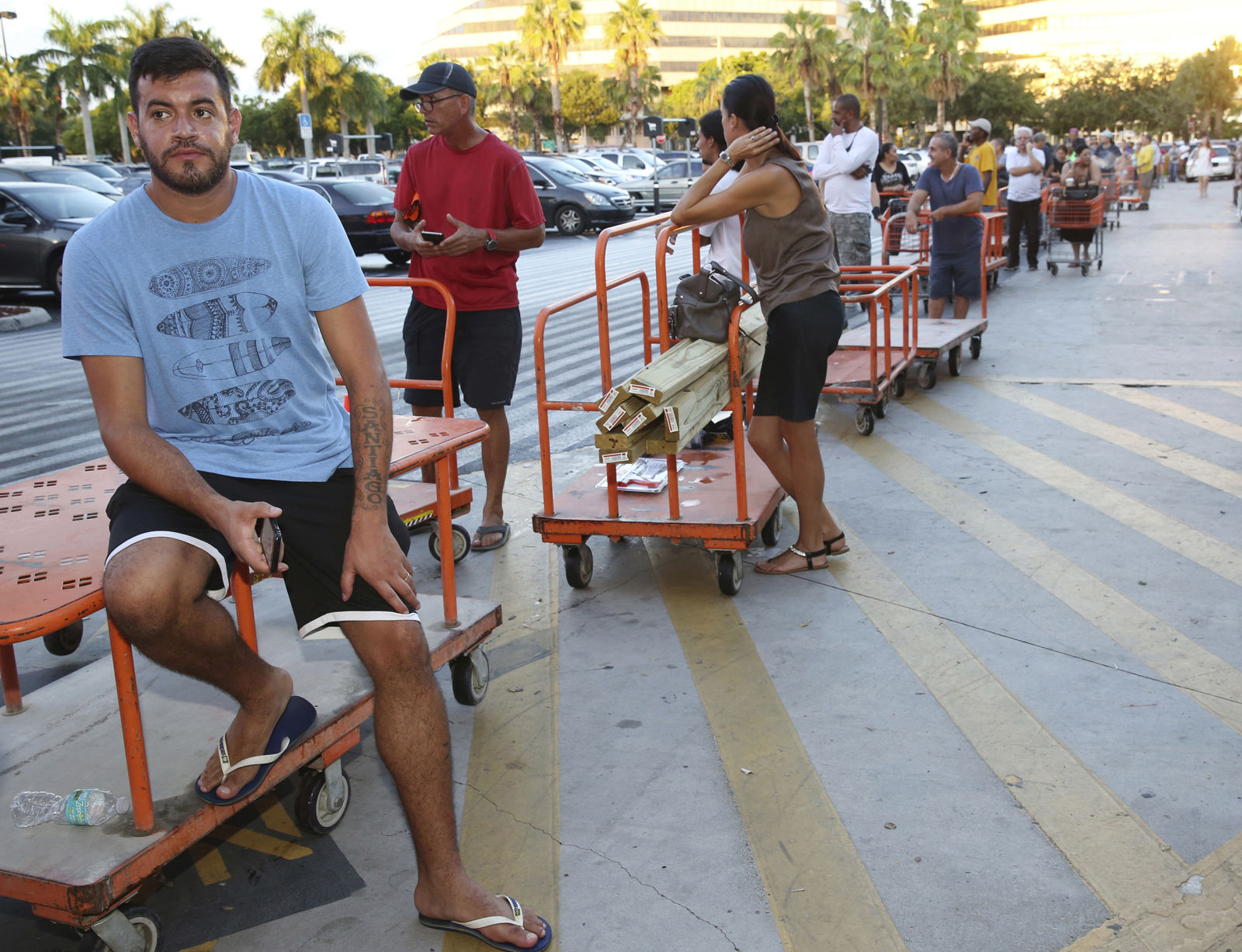 Max Garcia, of Miami, waits in a line since dawn to purchase plywood sheets at The Home Depot store in North Miami, Fla., Wednesday, Sept. 6, 2017. Florida residents are preparing for the possible landfall of Hurricane Irma, the most powerful Atlantic Ocean hurricane in recorded history. (AP Photo/Marta Lavandier)