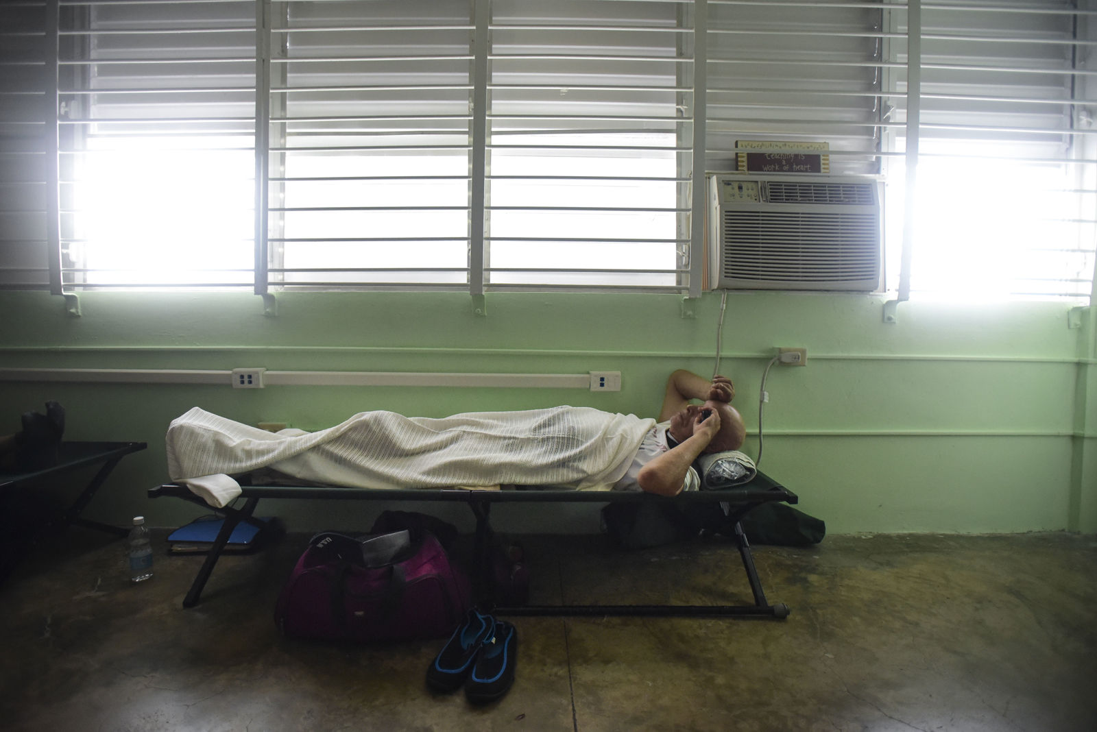 A man rests on a cot inside a shelter set up at the Berta Zalduondo elementary school during the passage of Hurricane Irma in Fajardo, northeast Puerto Rico, Wednesday, Sept. 6, 2017. Heavy rain and high winds lashed Puerto Ricoâ€™s northeast coast Wednesday as Hurricane Irma roared through Caribbean islands. (AP Photo/Carlos Giusti) NO PUBLICAR EN PUERTO RICO