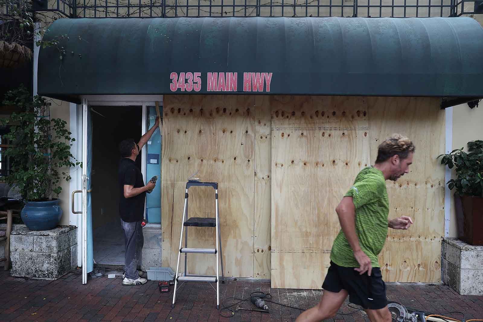 Samuel Bonia puts plywood over windows of a business as they prepare for Hurricane Irma on Sept. 6, 2017 in Miami, Florida. It's still too early to know where the direct impact of the hurricane will take place but the state of Florida is in the area of possible landfall.  (Photo by Joe Raedle/Getty Images)