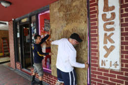 Noel Garcia and Mike Ehlis (L-R) put plywood over windows of Noel's business as they prepare for Hurricane Irma on Sept. 6, 2017 in Miami, Florida. It's still too early to know where the direct impact of the hurricane will take place but the state of Florida is in the area of possible landfall.  (Photo by Joe Raedle/Getty Images)