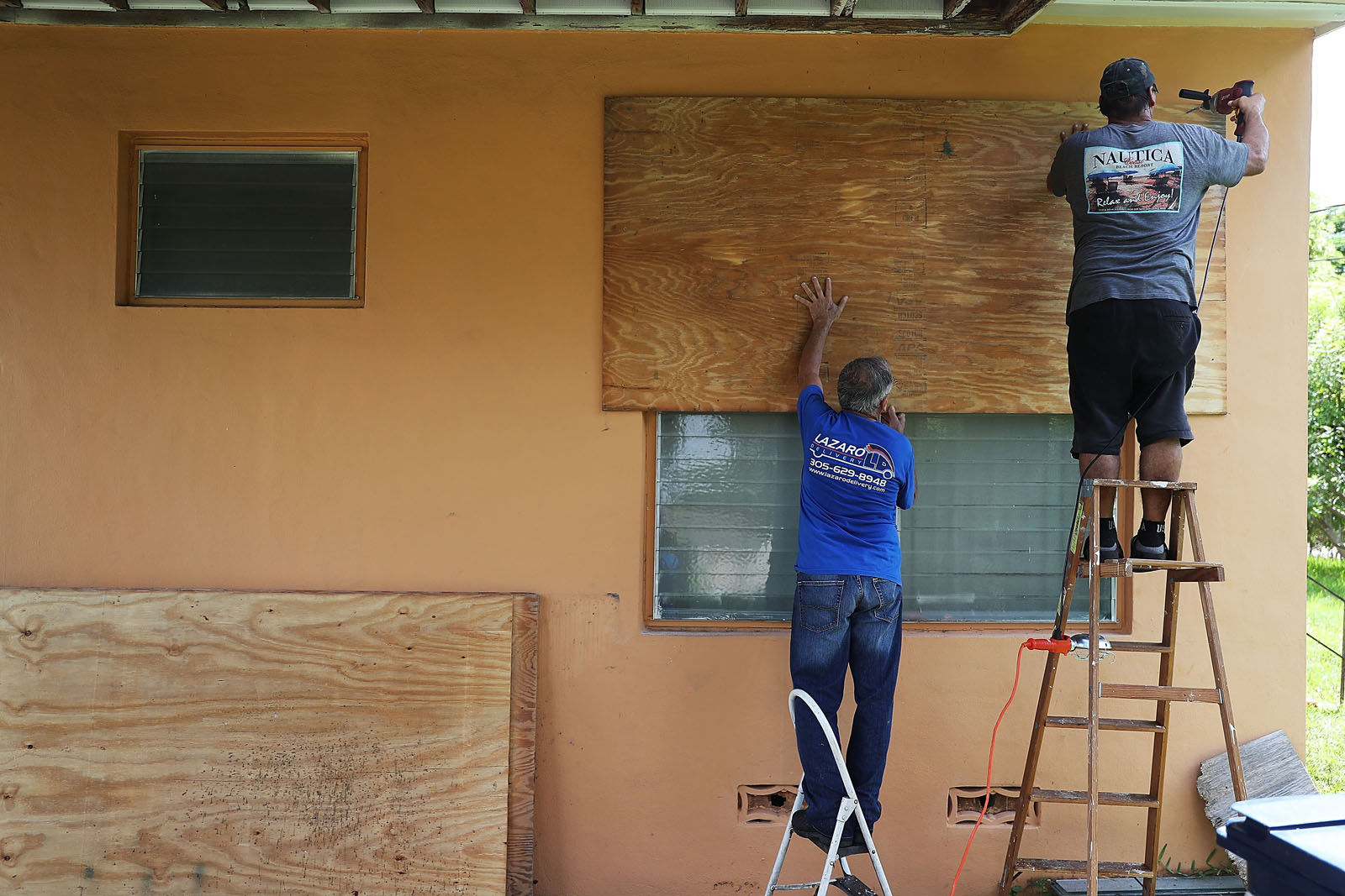 People put up shutters as they prepare a family members house for Hurricane Irma on Sept. 6, 2017 in Miami, Florida. It's still too early to know where the direct impact of the hurricane will take place but the state of Florida is in the area of possible landfall.  (Photo by Joe Raedle/Getty Images)