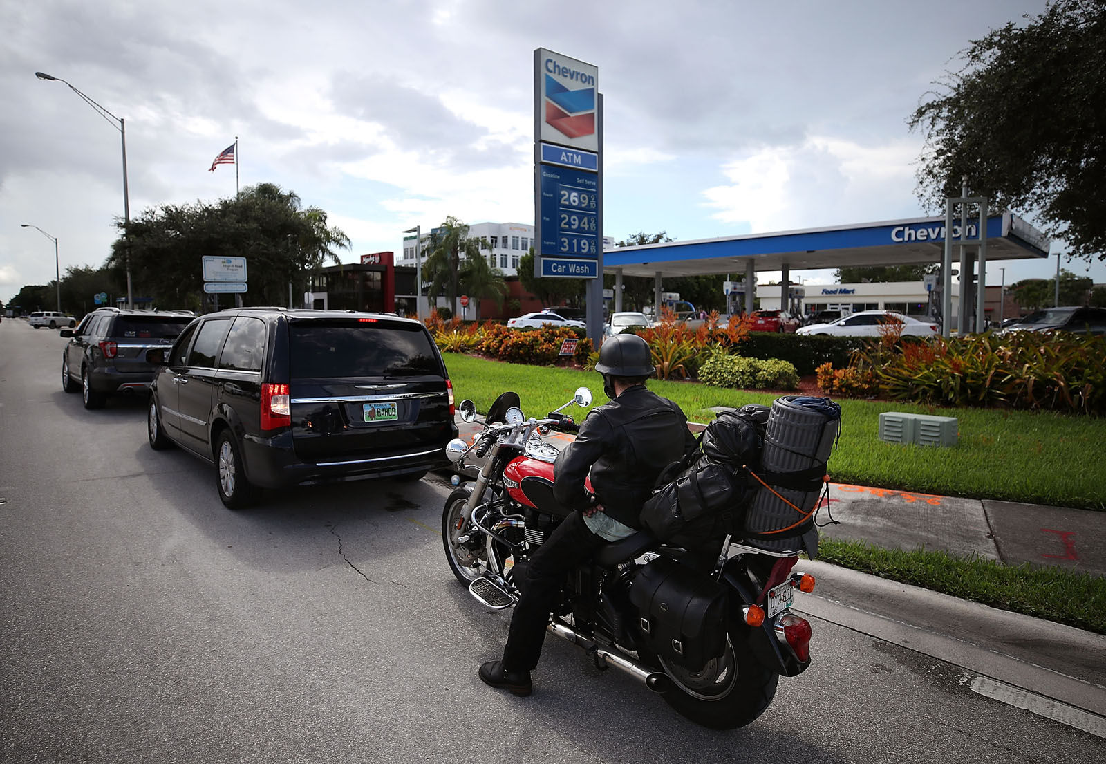 A motorcyclist waits in long gas line as people prepare for Hurricane Irma on Sept. 6, 2017 in Doral, Florida. It's still too early to know where the direct impact of the hurricane will take place but the state of Florida is in the area of possible landfall.   (Photo by Mark Wilson/Getty Images)