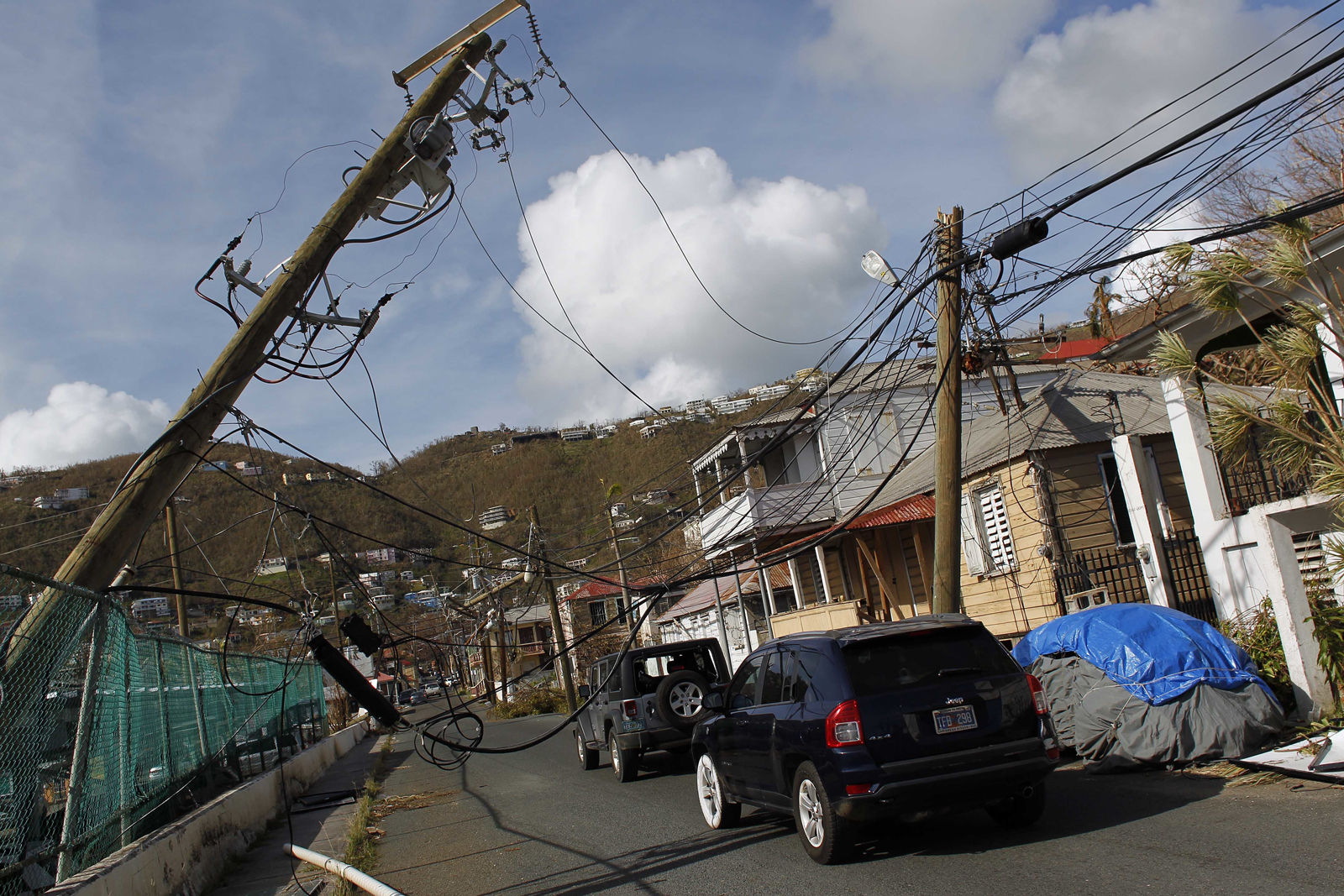 Power lines are damaged after the passage of Hurricane Irma in Charlotte Amalie, St. Thomas, U.S. Virgin Islands, Sunday, Sept. 10, 2017.  The storm ravaged such lush resort islands as St. Martin, St. Barts, St. Thomas, Barbuda and Anguilla. (AP Photo/Ricardo Arduengo)