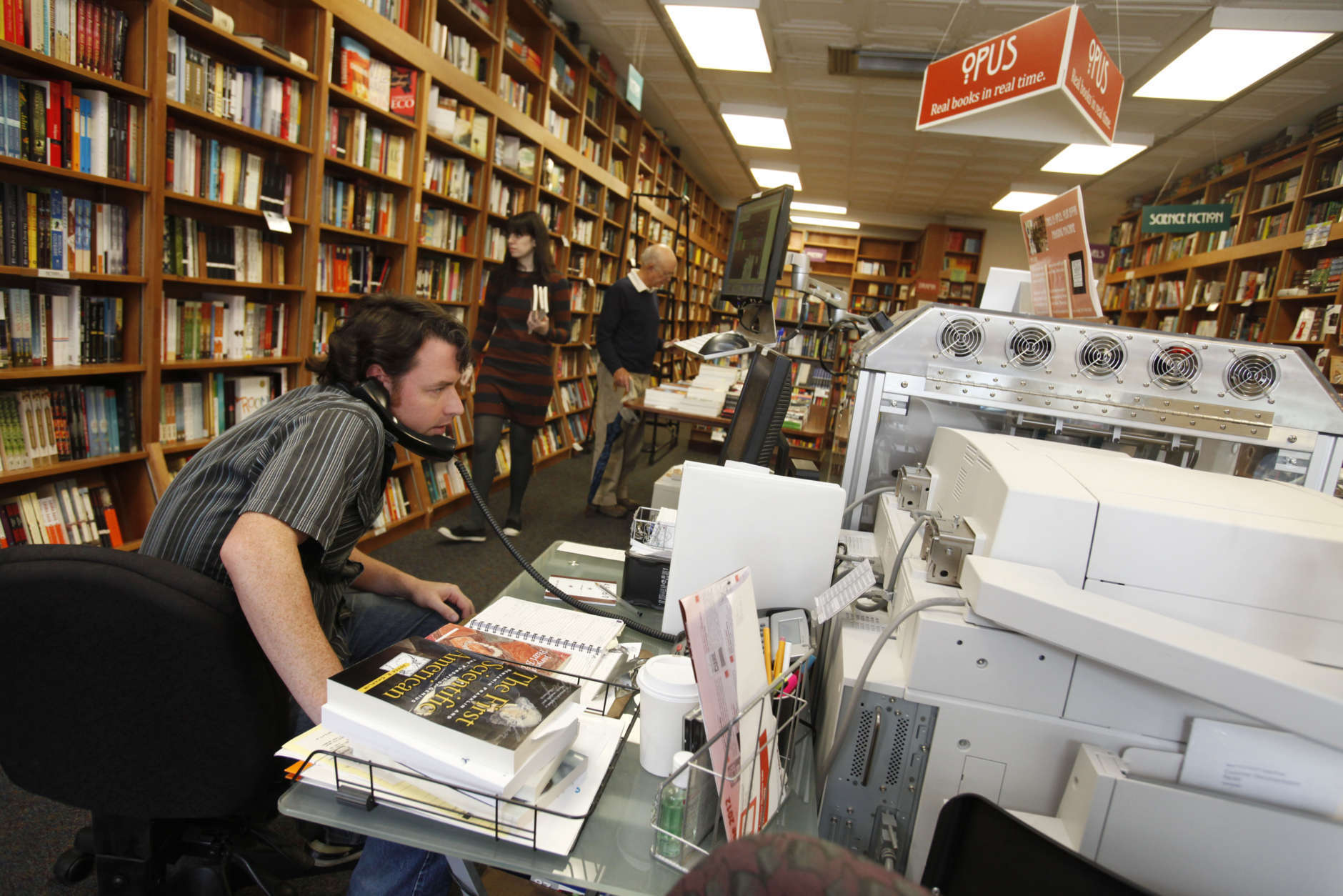 In this June 5, 2012, photo, Bill Leggett works on the Espresso Book Machine, known as Opus, at Politics and Prose bookstore in Washington. Self-publishing has been made easier since the macine by On Demand Books debuted in 2006. The machine also can makes copies of out-of-print editions. The first machine was installed briefly at the World Banks bookstore. Through a partnership with Xerox, the company now has machines in about 70 bookstores and libraries across the world including London; Tokyo; Amsterdam; Abu Dhabi, United Arab Emirates; Melbourne, Australia; and Alexandria, Egypt. (AP Photo/Jacquelyn Martin)