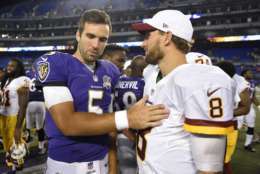 FILE - In this Aug. 29, 2015, file photo, Baltimore Ravens quarterback Joe Flacco, left, chats with Washington Redskins quarterback Kirk Cousins after a preseason NFL football game in Baltimore. If the cornerstone of a great rivalry is proximity between the teams, the Redskins and Ravens would be nasty adversaries. Both teams play their home games in Maryland at stadiums located just 32 miles apart. (AP Photo/File)