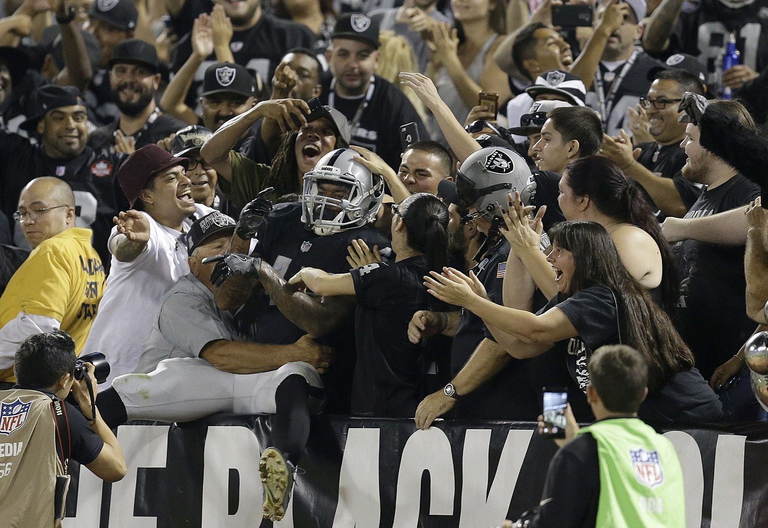 Oakland Raiders running back George Atkinson III (45) celebrates with fans during the second half of an NFL preseason football game against the Seattle Seahawks in Oakland, Calif., Thursday, Aug. 31, 2017. Atkinson had scored an apparent touchdown that called back on penalty. (AP Photo/Ben Margot)