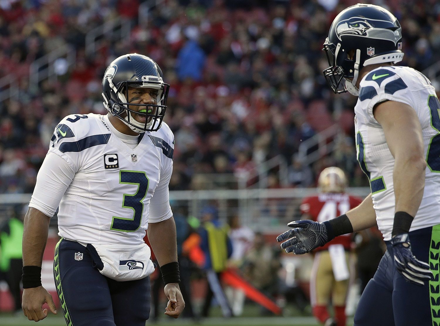 Seattle Seahawks quarterback Russell Wilson (3) and tight end Luke Willson, right, celebrate after connecting on a touchdown pass against the San Francisco 49ers during the first half of an NFL football game in Santa Clara, Calif., Sunday, Jan. 1, 2017. (AP Photo/Marcio Jose Sanchez)