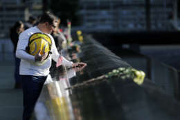 James Taormina, whose brother Dennis Taormina was killed during the Sept. 11 attacks stands by the side of the north waterfall pool before the a ceremony at ground zero in New York, Monday, Sept. 11, 2017. Holding photos and reading names of loved ones lost 16 years ago, 9/11 victims' relatives marked the anniversary of the attacks with a solemn and personal ceremony. (AP Photo/Seth Wenig)