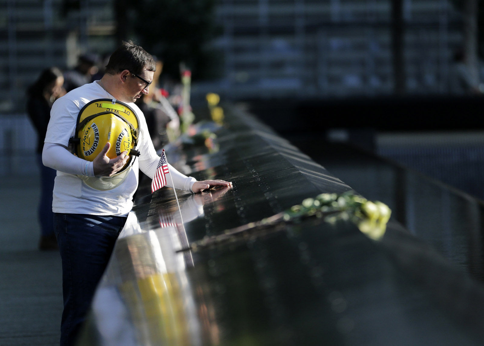 James Taormina, whose brother Dennis Taormina was killed during the Sept. 11 attacks stands by the side of the north waterfall pool before the a ceremony at ground zero in New York, Monday, Sept. 11, 2017. Holding photos and reading names of loved ones lost 16 years ago, 9/11 victims' relatives marked the anniversary of the attacks with a solemn and personal ceremony. (AP Photo/Seth Wenig)