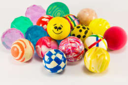 group of colorful bouncing rubber balls over white background