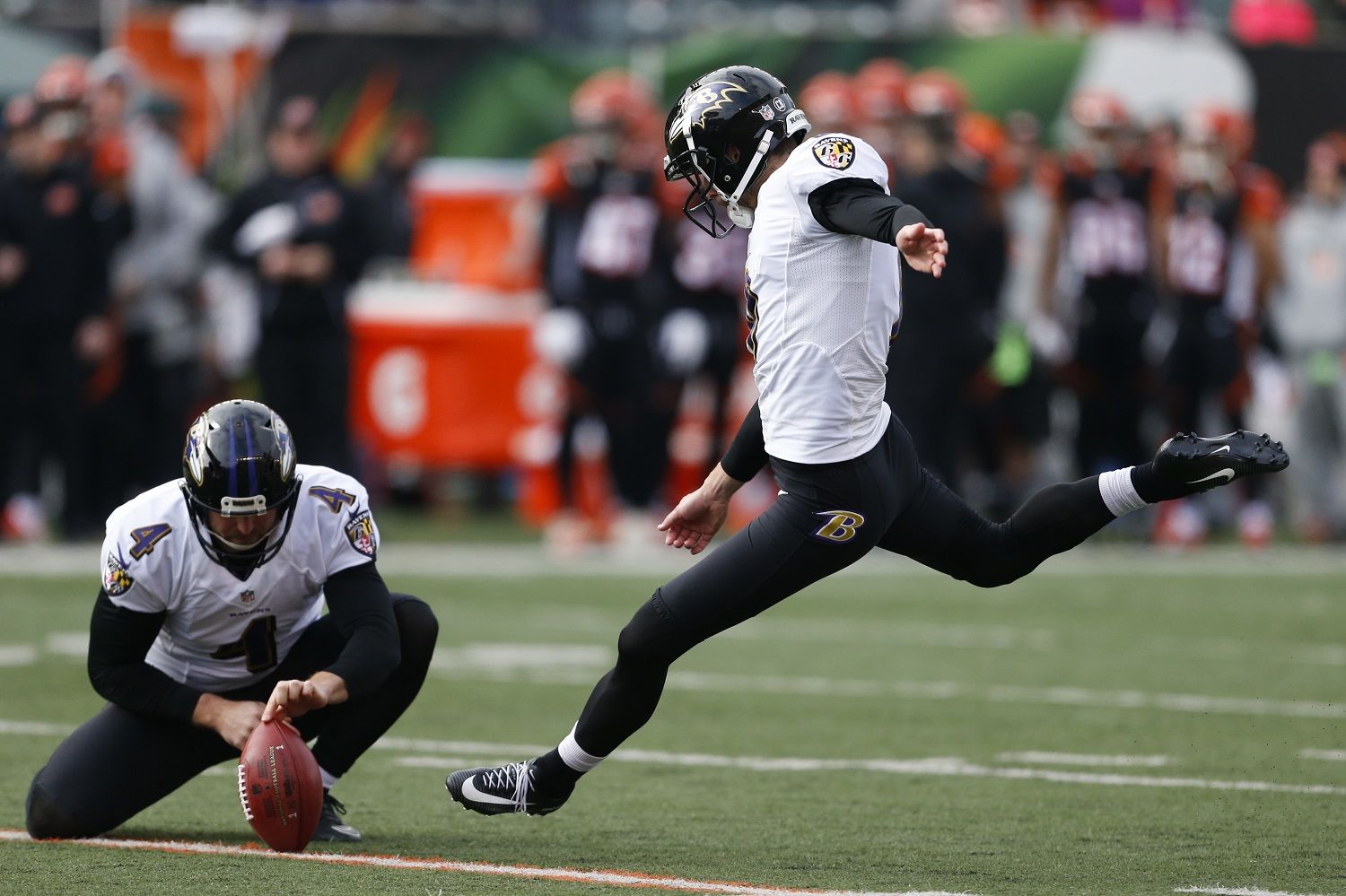 Baltimore Ravens kicker Justin Tucker (9) kicks a field goal alongside punter Sam Koch (4) in the first half of an NFL football game against the Cincinnati Bengals, Sunday, Jan. 1, 2017, in Cincinnati. (AP Photo/Gary Landers)