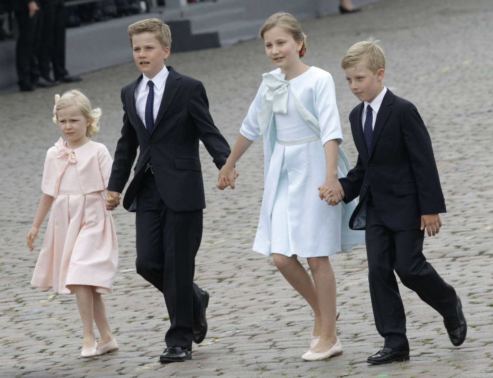 Belgium's Crown Princess Elisabeth, second right, walks with her brothers Gabriel, second left, and Emmanuel, right, and her sister Eleonore, left, during a military parade on Belgian National Day, in front of the Royal Palace in Brussels, Monday, July 21, 2014. (AP Photo/Yves Logghe)