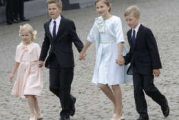Belgium's Crown Princess Elisabeth, second right, walks with her brothers Gabriel, second left, and Emmanuel, right, and her sister Eleonore, left, during a military parade on Belgian National Day, in front of the Royal Palace in Brussels, Monday, July 21, 2014. (AP Photo/Yves Logghe)
