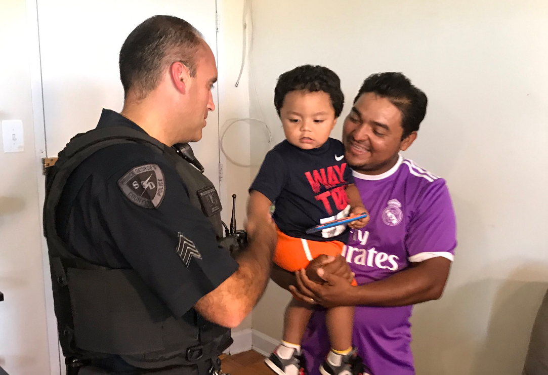 Sgt. Nick Cicale visits with Carlos Sr. (WTOP/Michelle Basch)