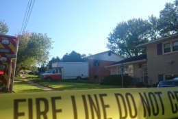 Photo shows fire tape in front of a home.
