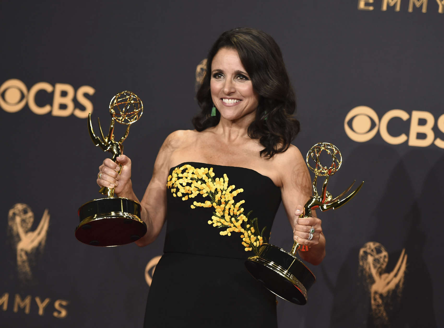Julia Louis-Dreyfus poses in the press room with her awards for outstanding lead actress in a comedy series and outstanding comedy series for "Veep" at the 69th Primetime Emmy Awards on Sunday, Sept. 17, 2017, at the Microsoft Theater in Los Angeles. (Photo by Jordan Strauss/Invision/AP)