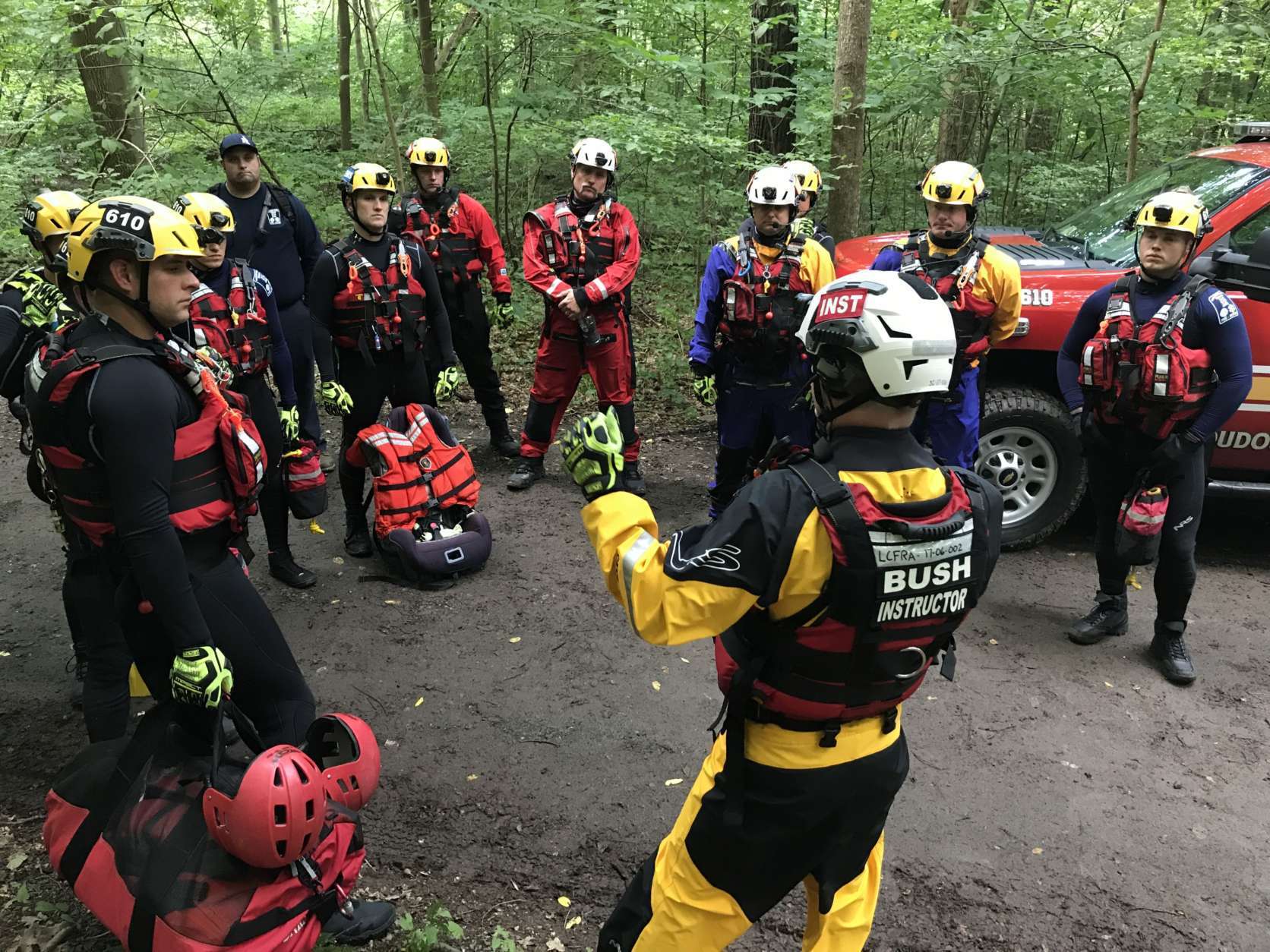 Members of the Loudoun County swift water rescue team get a briefing before starting a training session Friday in the Potomac River.  (WTOP/Michelle Basch)