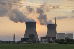 Ein laufendes Atomkraftwerk gegen den Abendhimmel fotografiert.