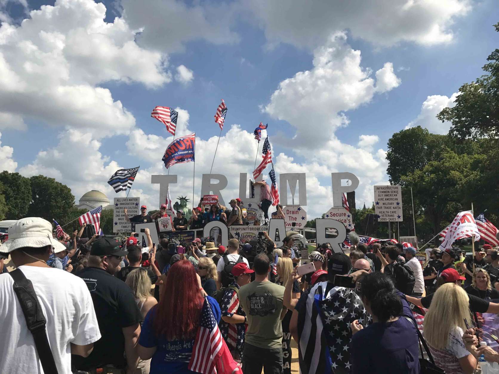 Dozens of rally goers turned out in front of Smithsonian Institute's National Museum of American History, cheering the president. (WTOP/Dick Uliano) 