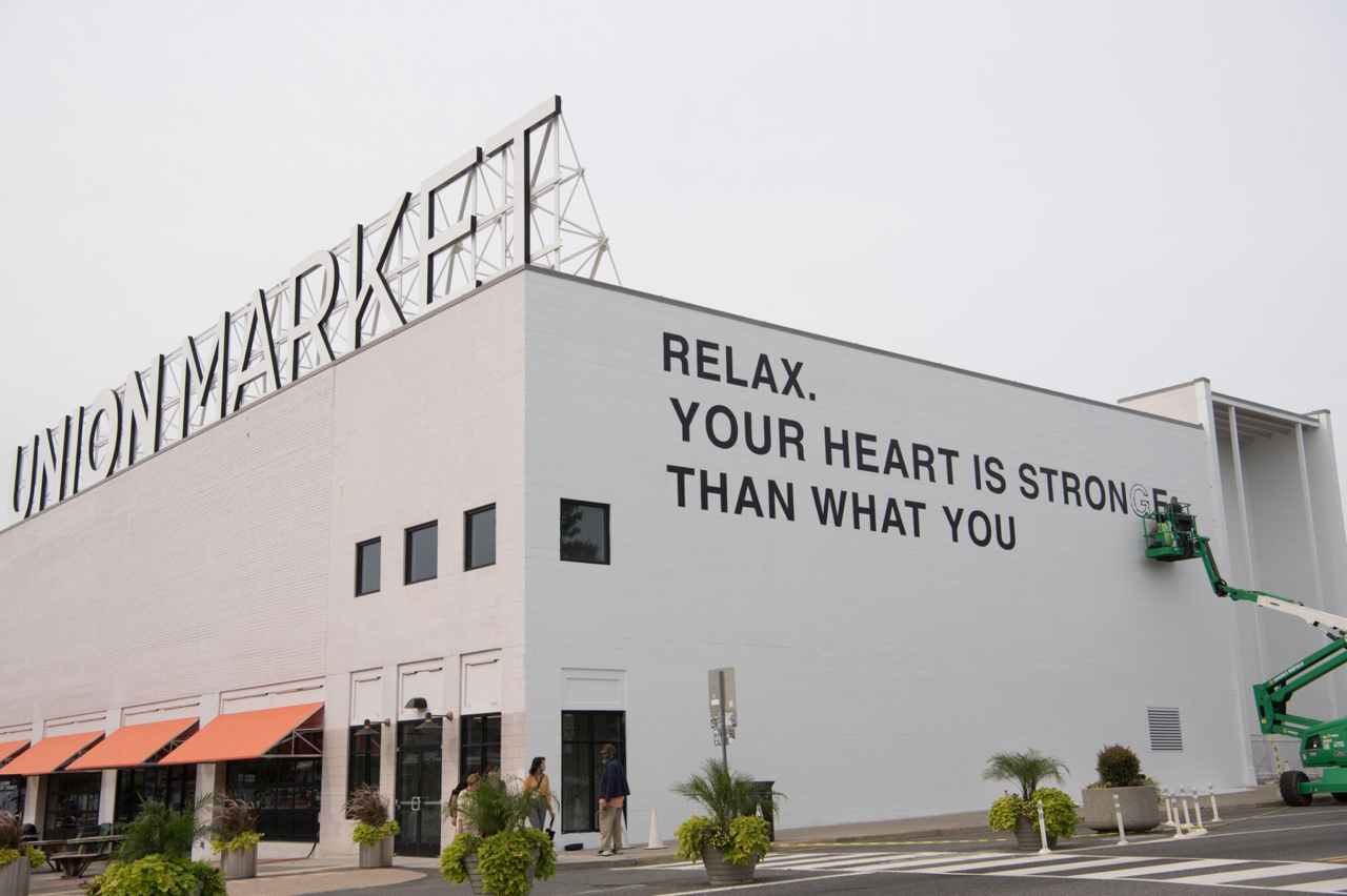 Union Market partners with Hirshhorn to present a public art mural by artist Yoko Ono - the current image is the installation in progress. (Emma McAlary)
