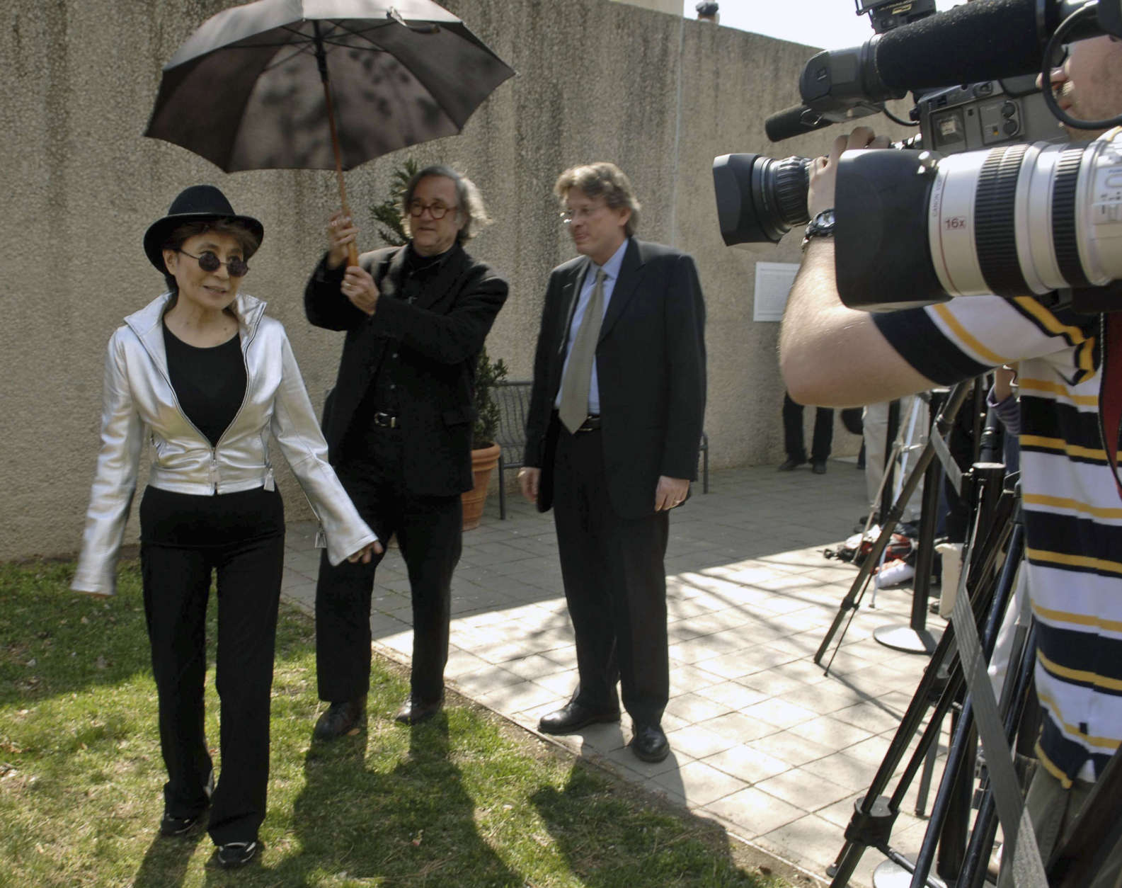 Yoko Ono, left, walks past the press before dedicating the "Wish Tree for Washington D.C." at the Hirshhorn Museum and Sculpture Garden on Monday, April 2, 2007, in Washington. (AP Photo/Kevin Wolf)
