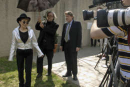 Yoko Ono, left, walks past the press before dedicating the "Wish Tree for Washington D.C." at the Hirshhorn Museum and Sculpture Garden on Monday, April 2, 2007, in Washington. (AP Photo/Kevin Wolf)