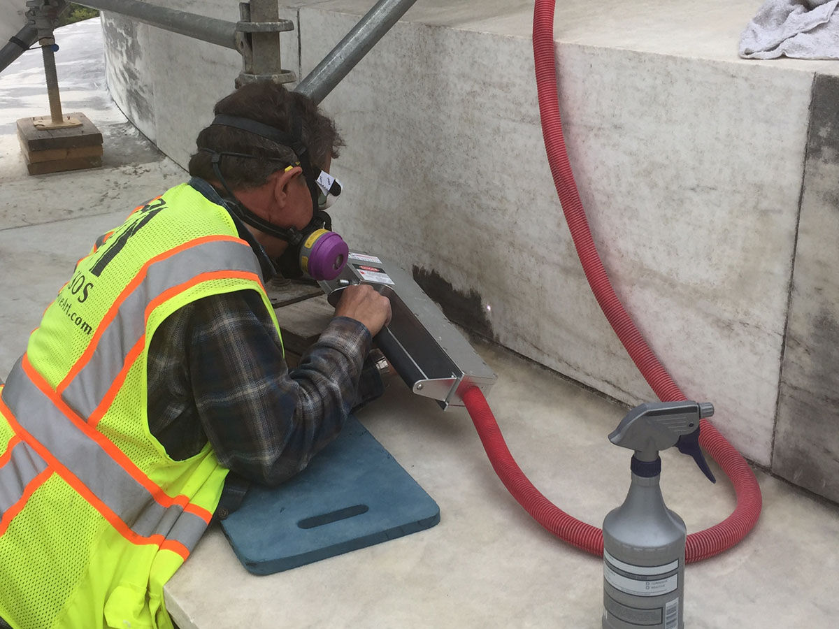 A worker uses the laser-abatement treatment to clean the Jefferson Memorial's biofilm. (Courtesy National Park Service)